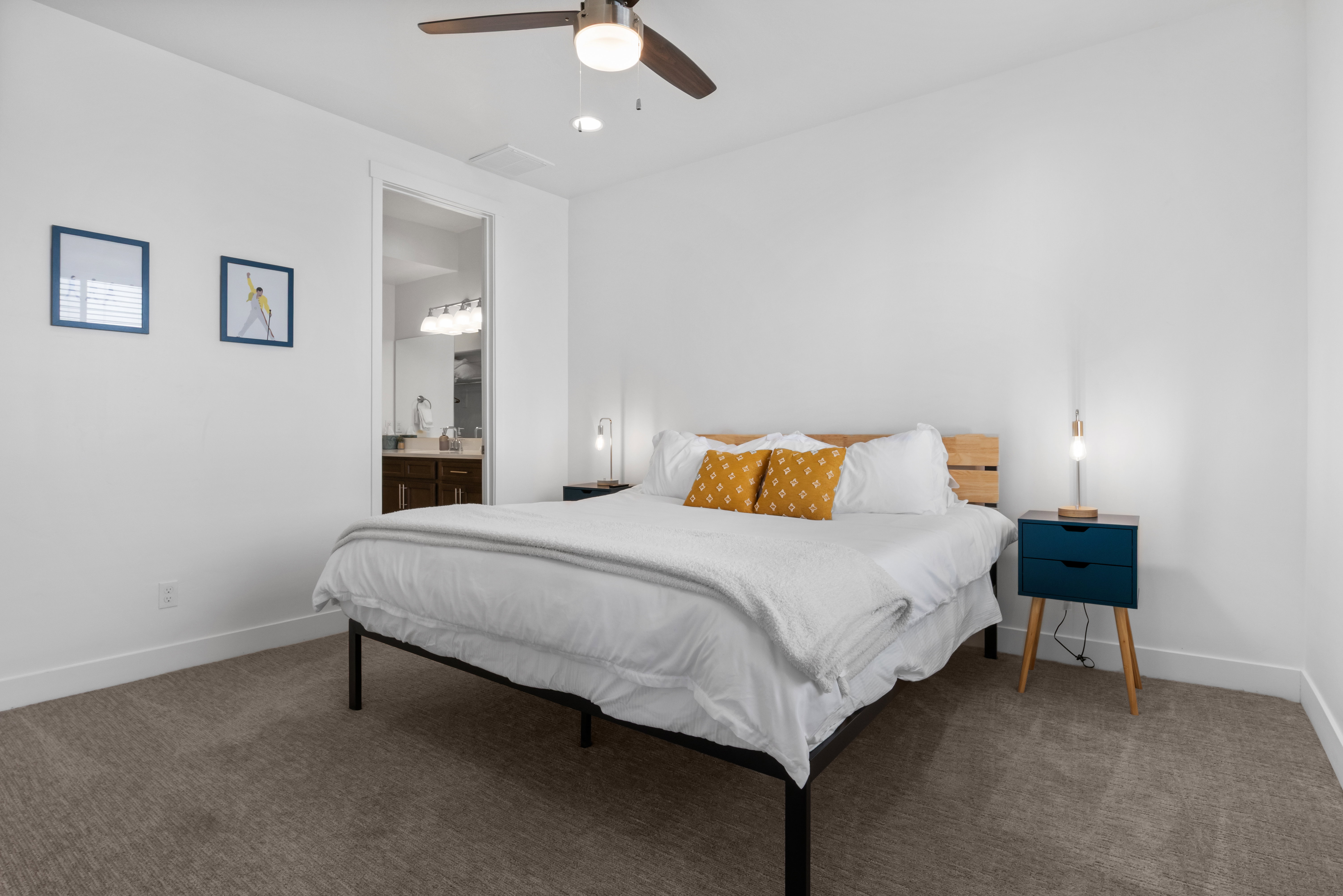 Spacious bedroom featuring plush gray carpeting and crisp white walls