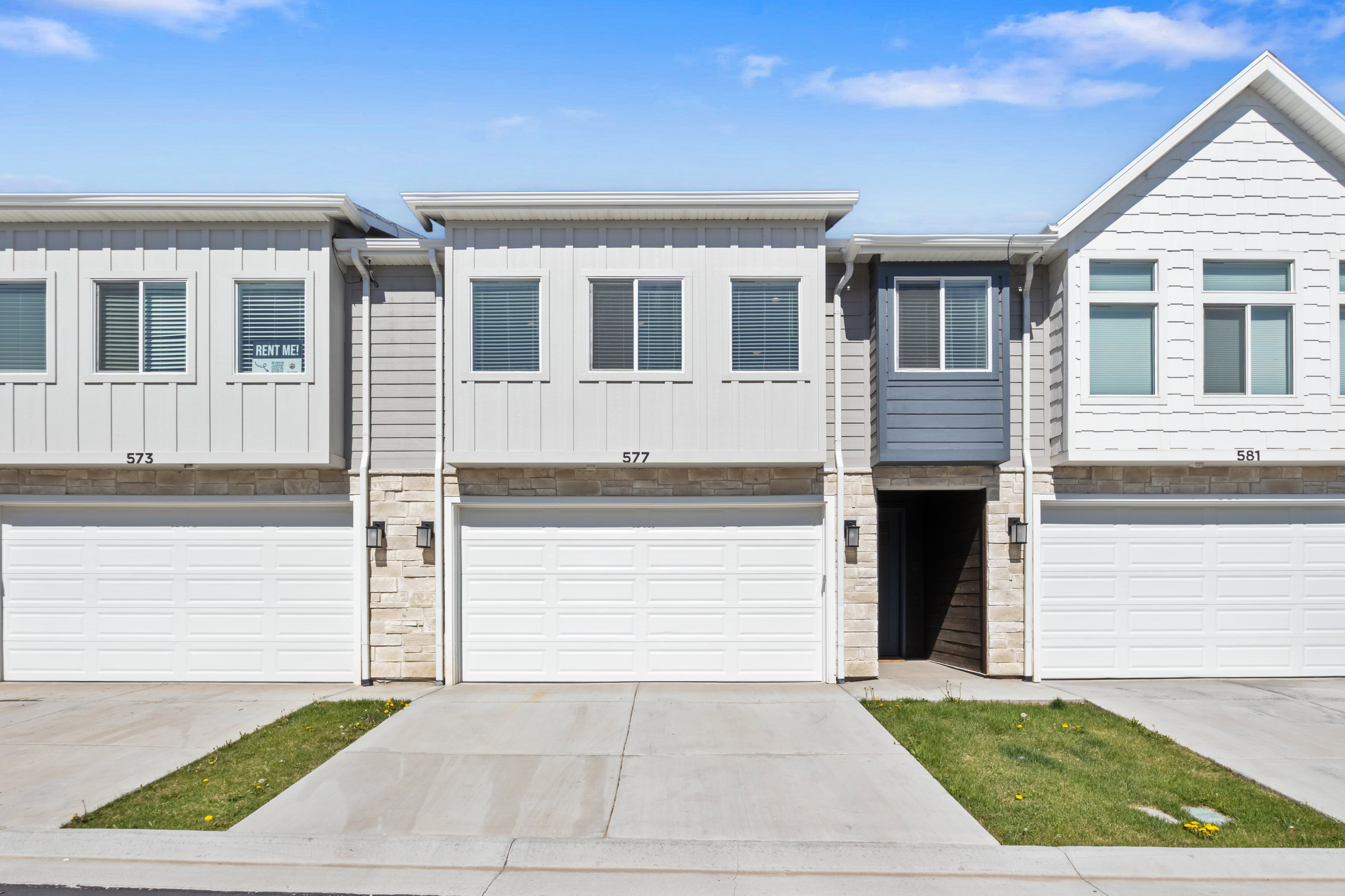 Modern townhome exterior featuring clean lines and a neutral color palette