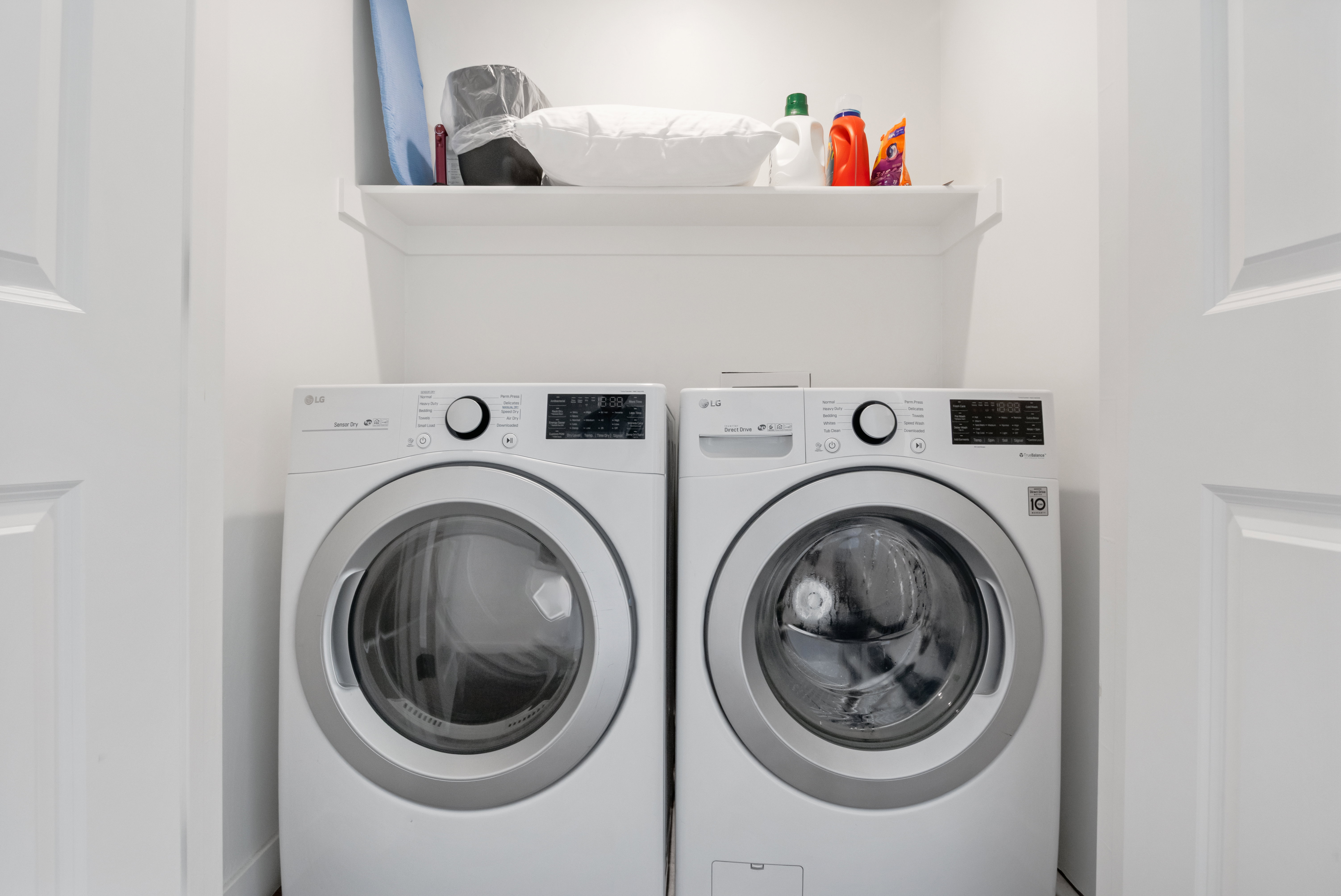 Dedicated laundry area featuring a white built-in shelf for storage and an appliance hookup for a washer and dryer
