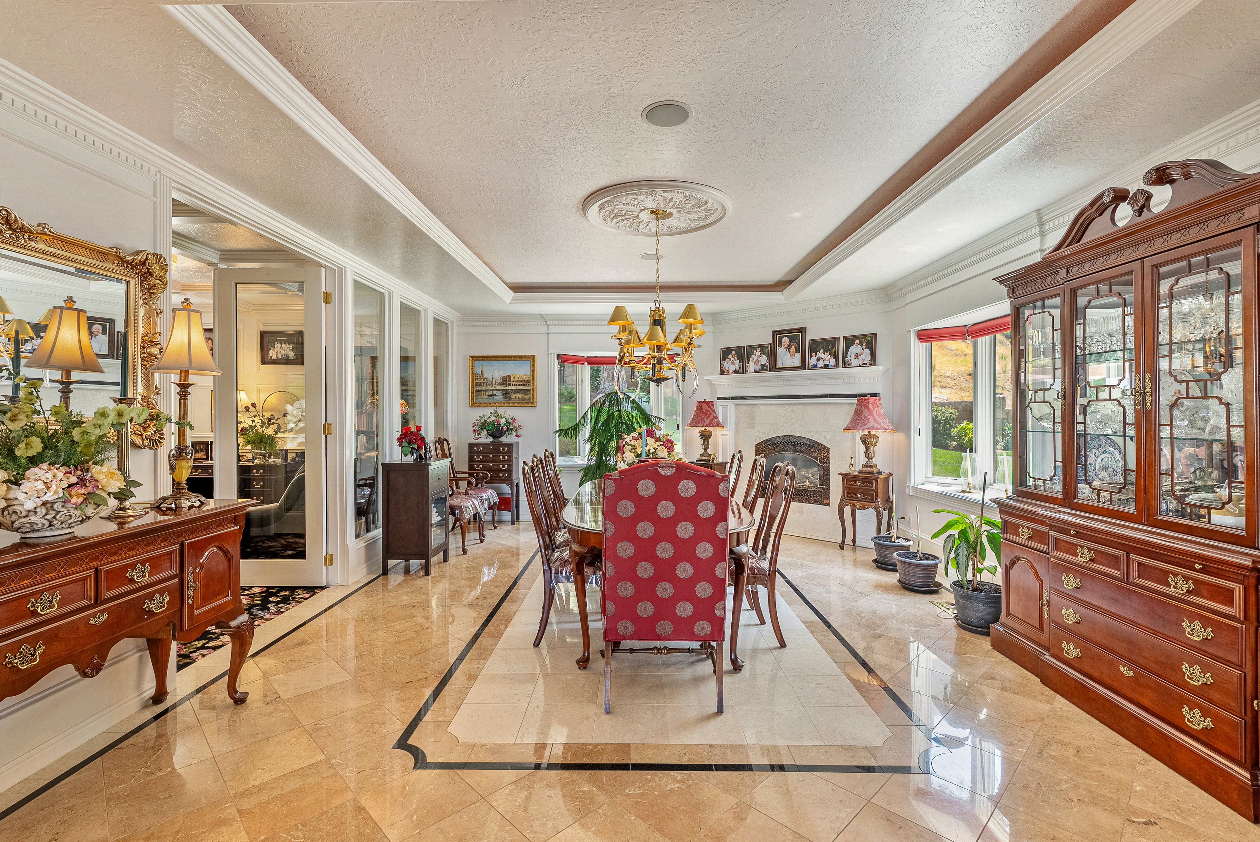 Formal dining area featuring extensive crown molding and an elegant tray ceiling with a medallion detail