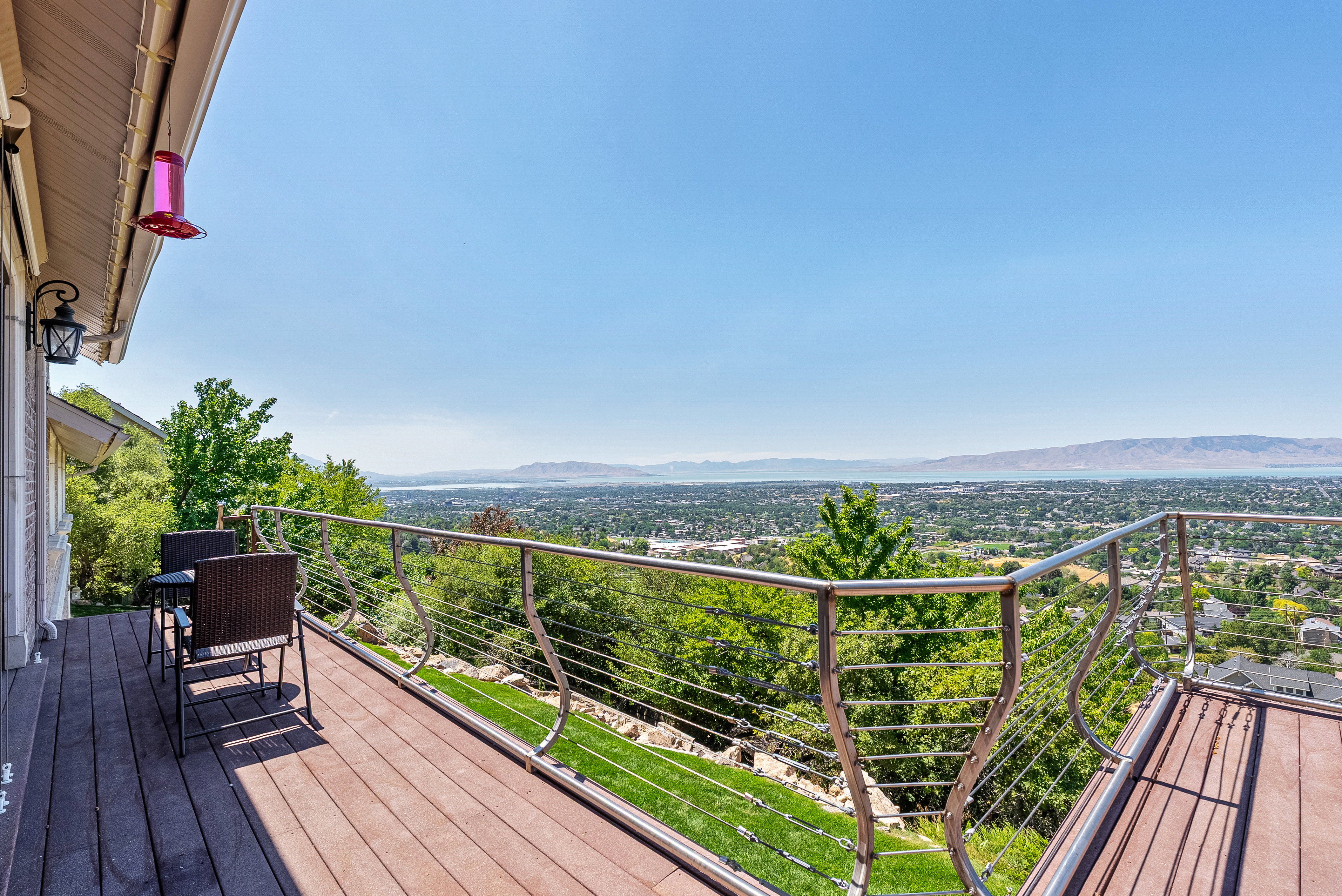 Expansive outdoor deck featuring wood-finish flooring and a cable railing system
