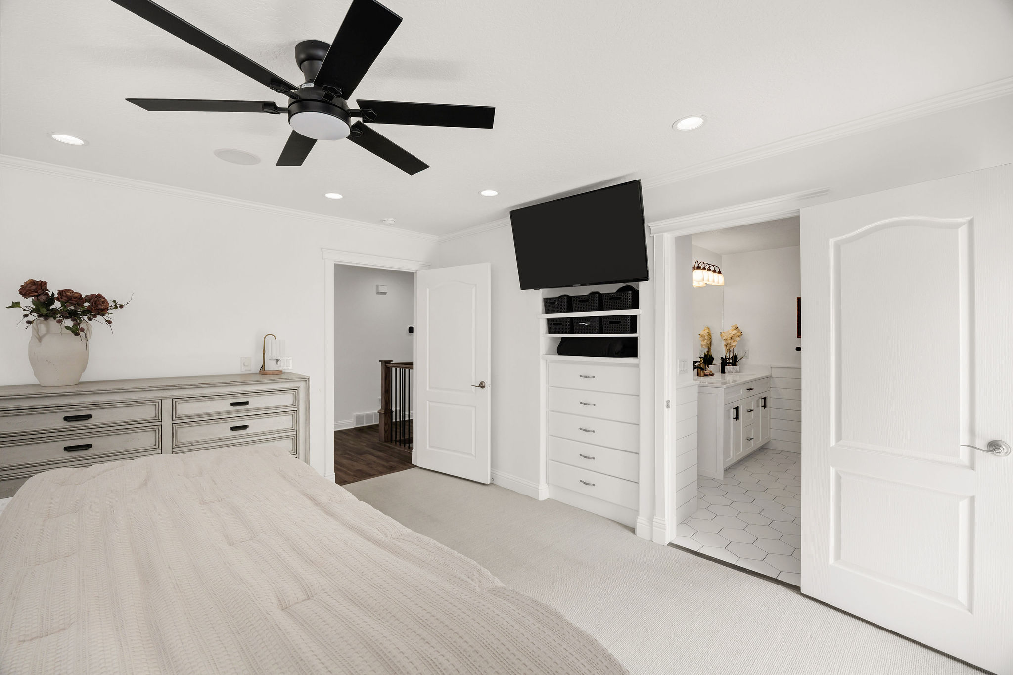Spacious room featuring white walls, recessed lighting, and a contemporary black ceiling fan