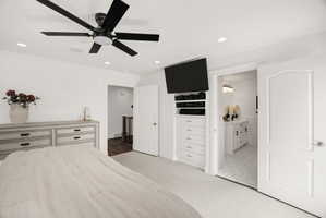 Spacious room featuring white walls, recessed lighting, and a contemporary black ceiling fan