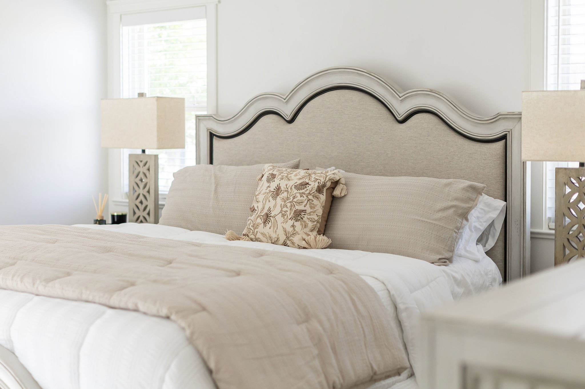Upholstered headboard with a distressed wood frame