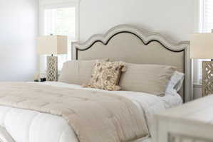 Upholstered headboard with a distressed wood frame