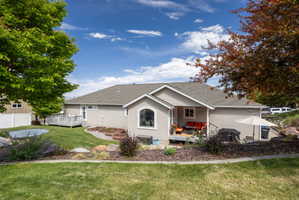 Expansive backyard featuring a manicured lawn, a large wood deck, and an additional covered patio area