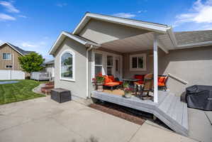 Covered deck area featuring composite decking and a stucco exterior