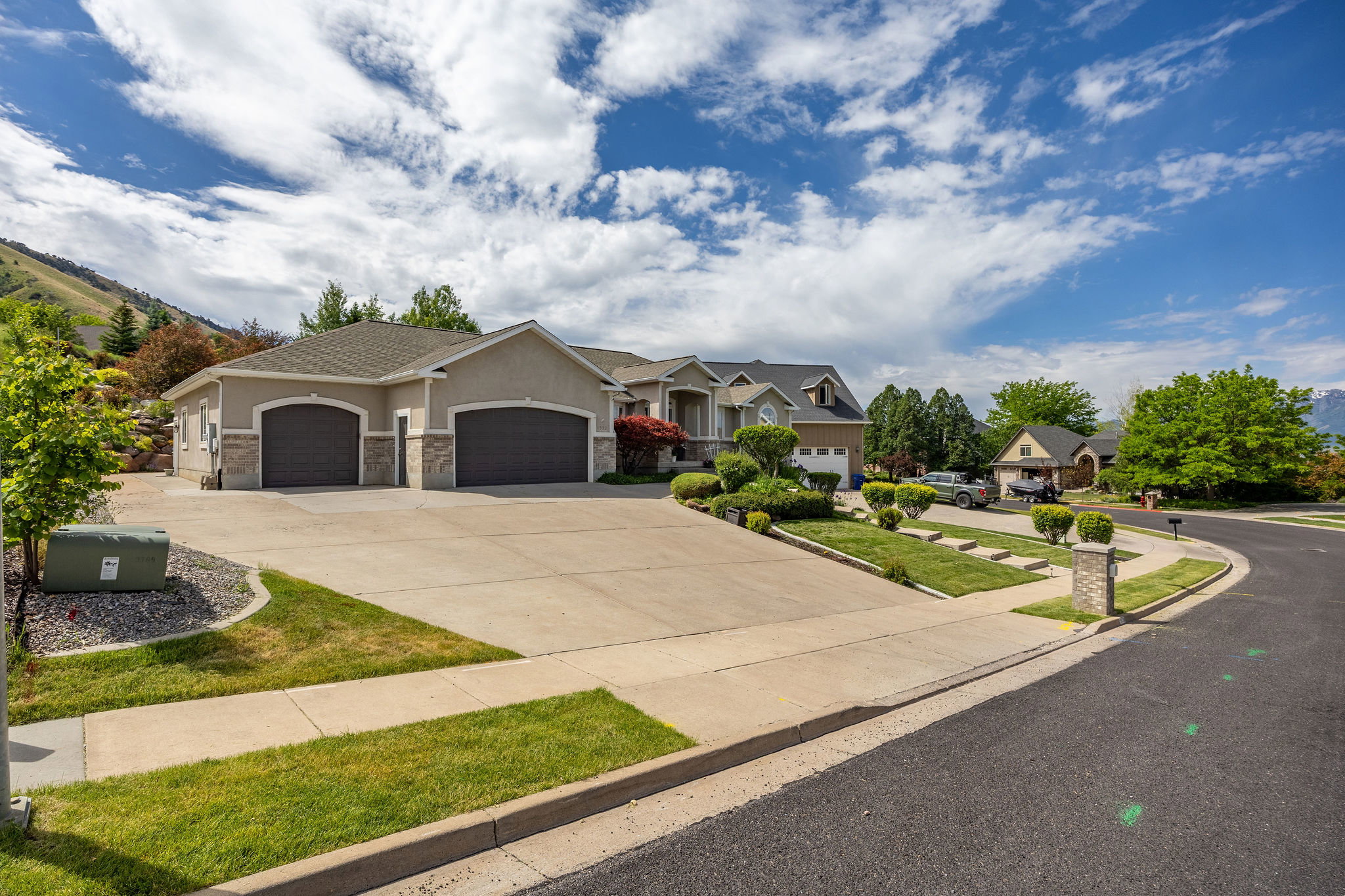 Contemporary stucco exterior with stone accents and a two-car garage