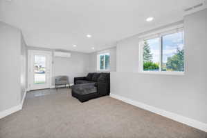 Spacious room featuring light gray walls, recessed lighting, and ample natural light from multiple windows