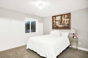 Recessed window with white trim, board and batten wall detailing, wall-to-wall carpeting, and a crystal chandelier