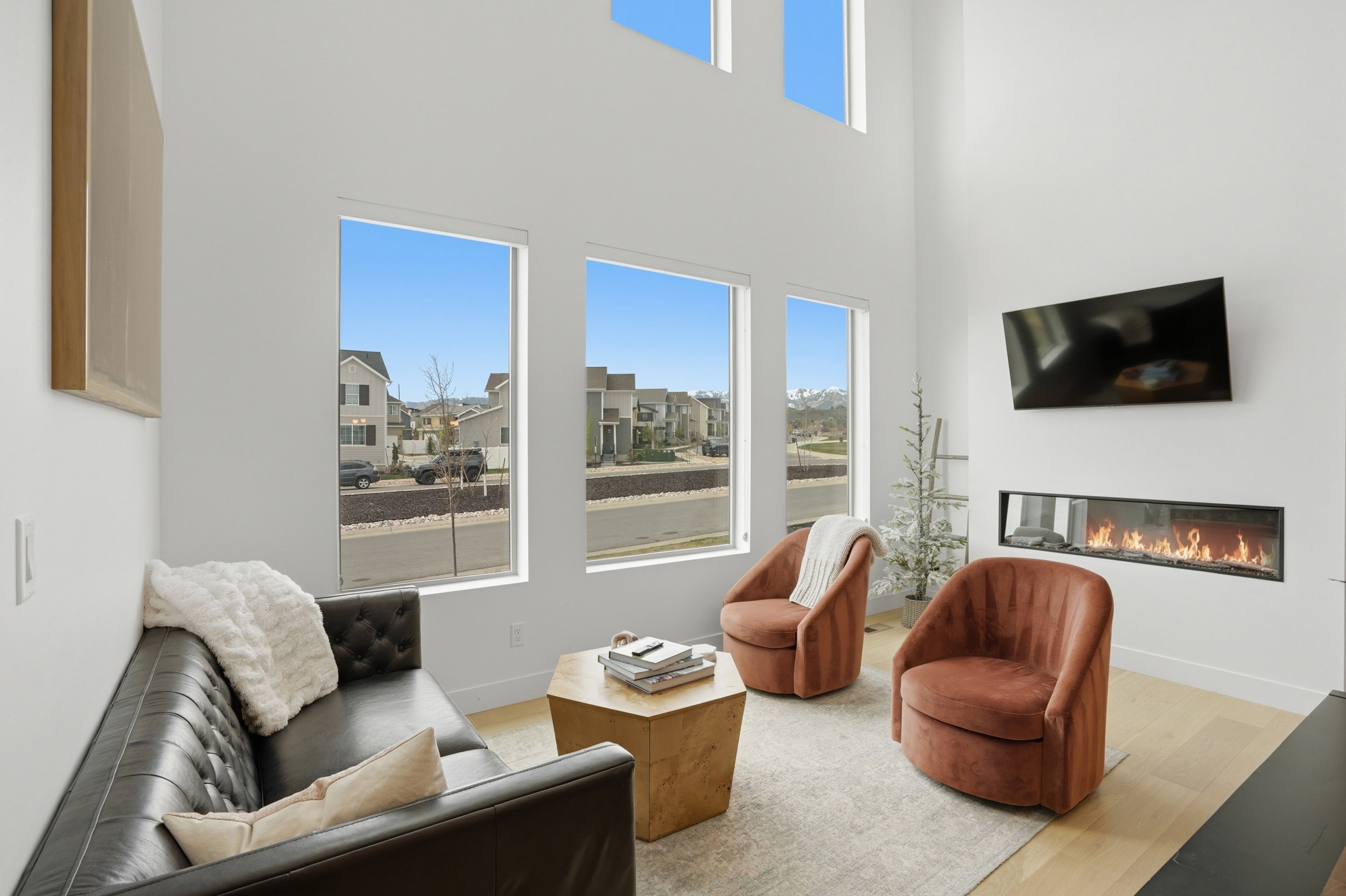 Expansive living space featuring soaring ceilings and light wood-finish flooring