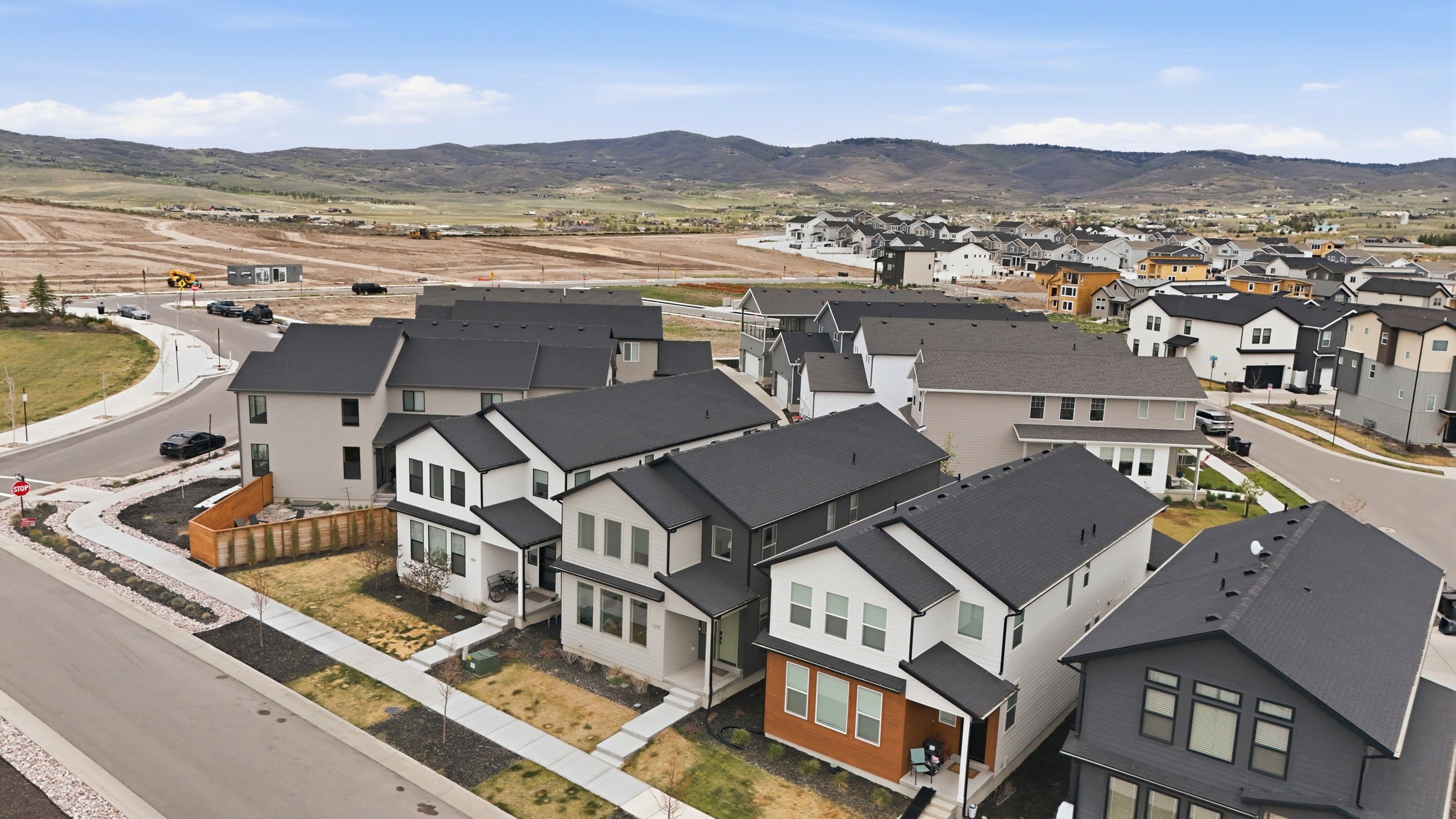 Modern residential development featuring contemporary architectural styles and dark asphalt shingle roofs