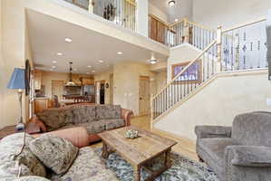 Two-story living area featuring wood-finish flooring and recessed lighting