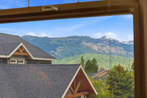 Mountain scenery featuring distant peaks and green hillsides