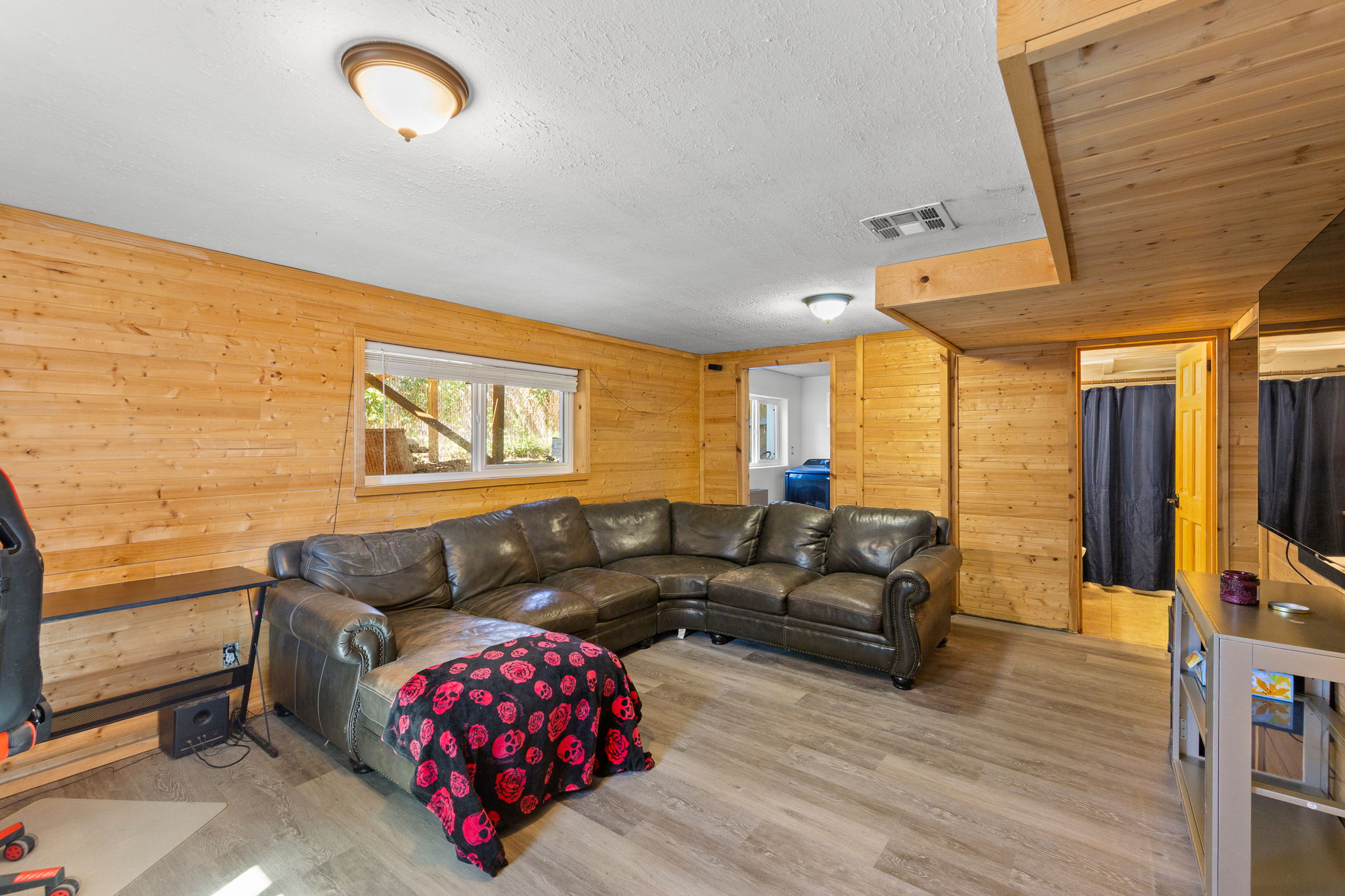 Room featuring natural wood-paneled walls and wood-finish flooring