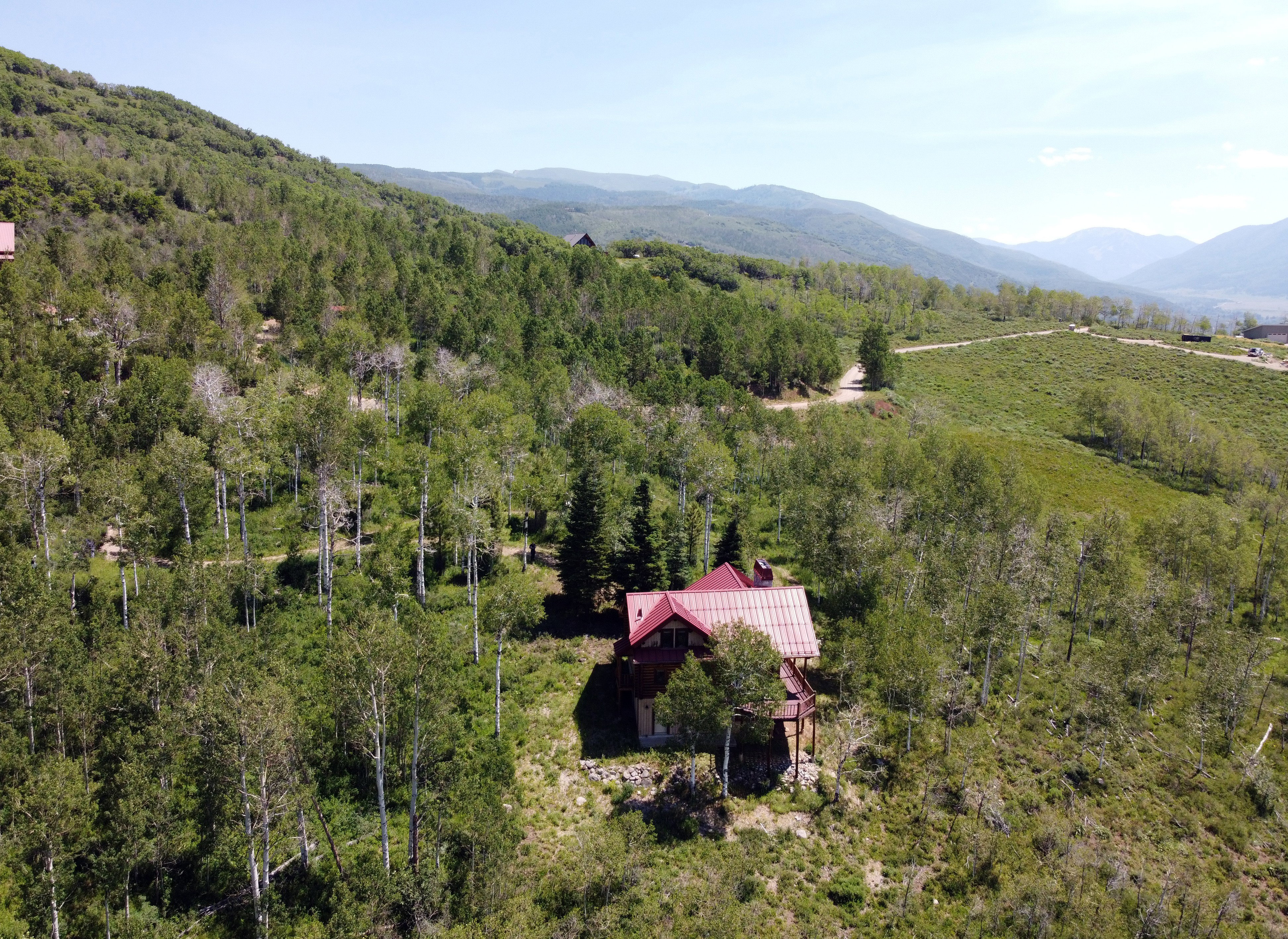 Aerial view back of cabin and surrounding  area.
