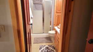 The bath has a large ceramic tile shower.