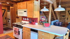 Kitchen view 4: The island, with trash compactor, microwave, range and pendant factory lighting.