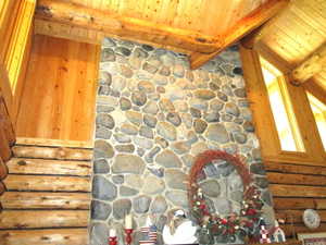 View of the upper great room showing the top of the river rock fireplace and the clerestory windows.