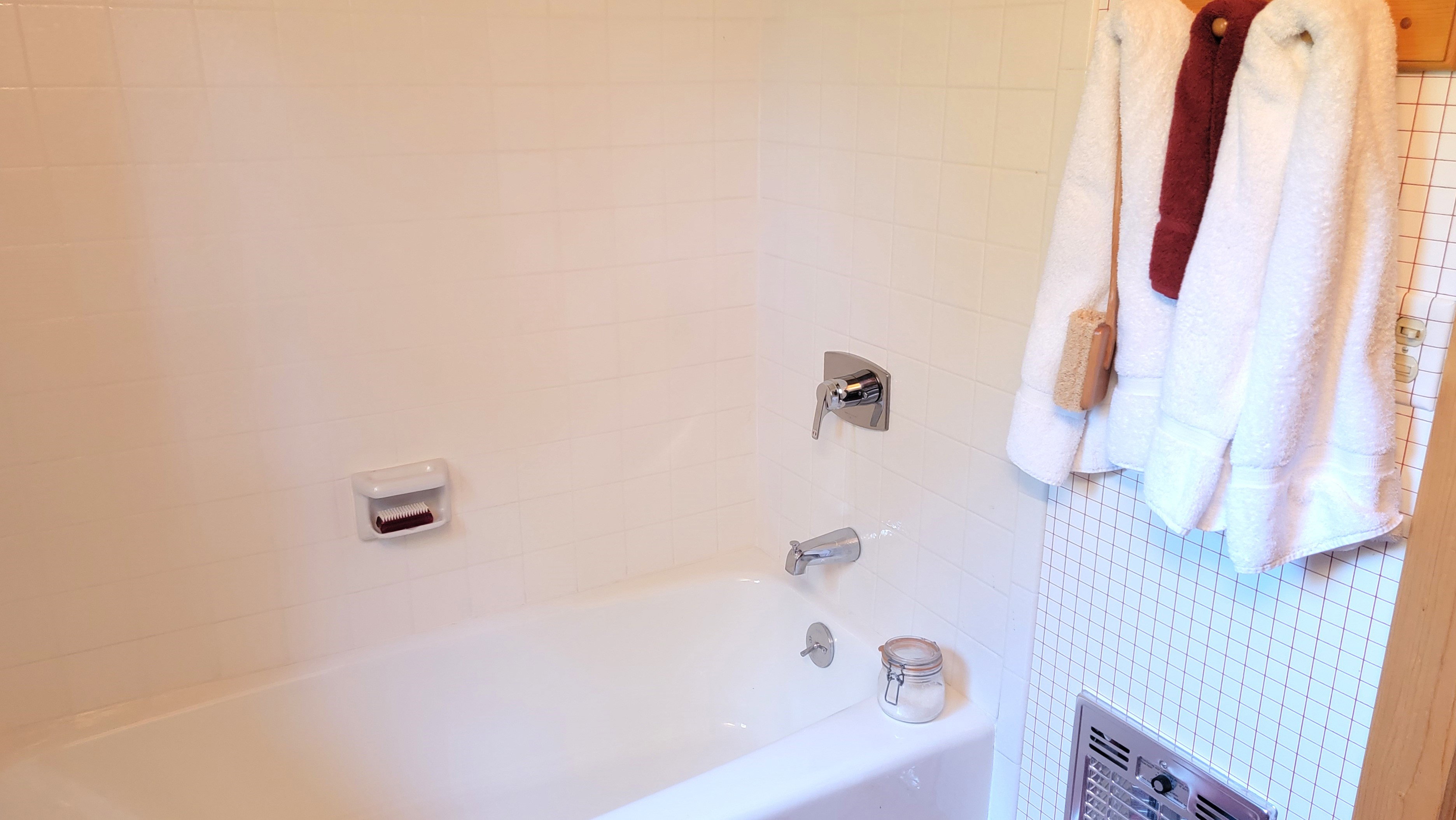 Ceramic tiled tub surround and porcelain tub/shower.