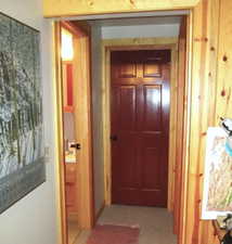 The lower level hallway to the bath, bunk room and utility room.