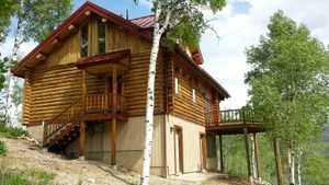The east and west side of the cabin, showing the back deck and doors to the family room and utility room.