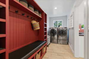 Mudroom featuring a built-in bench with storage, beadboard paneling, included washer and dryer