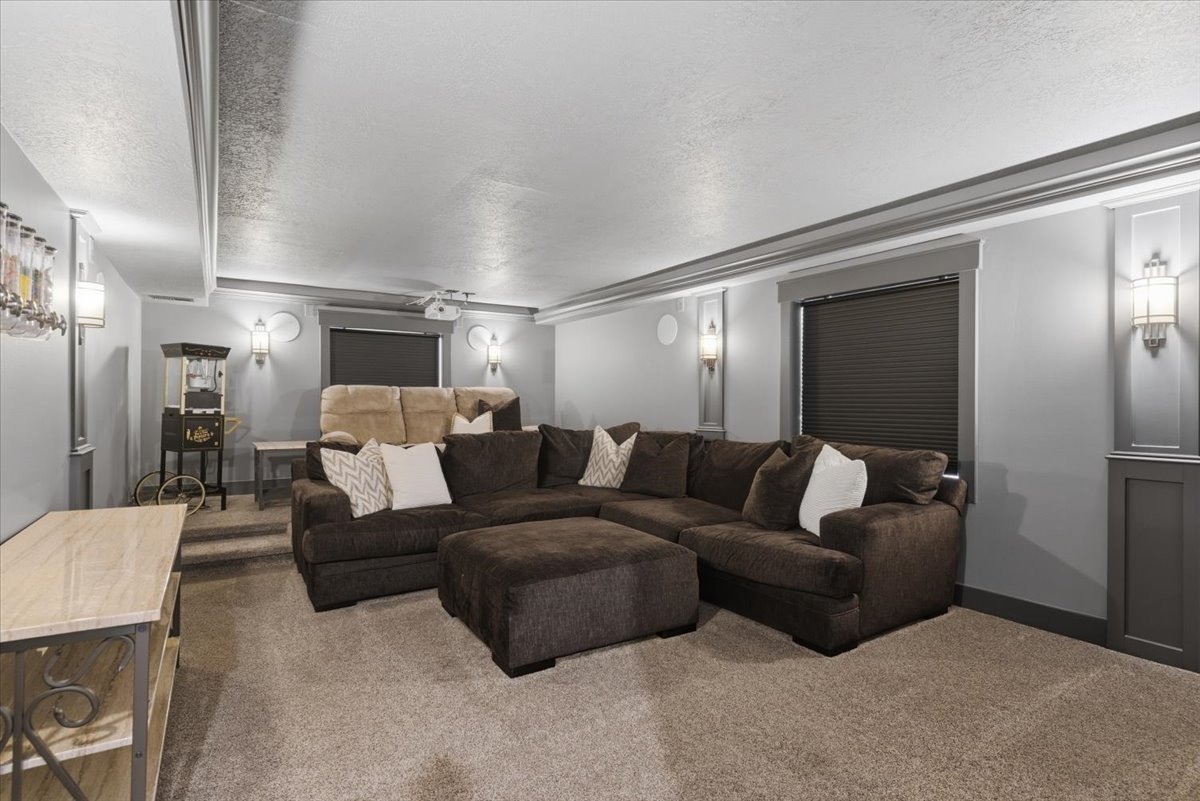 Large theater room featuring, recessed lighting, wall sconces, full projection and sound system
