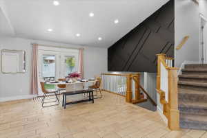 Dining area with light tile flooring, recessed lighting, and double glass panel doors opening to an exterior space
