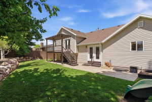 Expansive backyard featuring a manicured lawn, private pergola walkout from master bedroom and mature trees