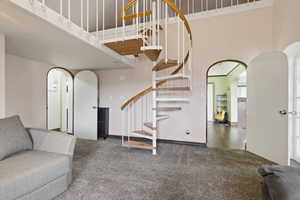 Spiral staircase featuring wood-finish treads and a white metal railing