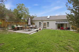 Expansive backyard featuring a large wooden deck, a second covered patio area, and a privacy fence