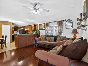 Open concept living area featuring wood-finish flooring and a ceiling fan