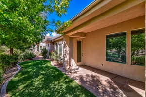 Patio with a textured concrete surface and a stucco exterior