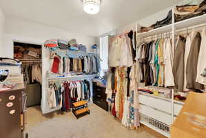 Custom closet organization system featuring multiple hanging rods and integrated shelving