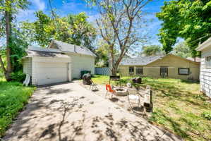 Concrete driveway leading to a detached garage