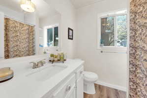 Bathroom featuring a white vanity with an integrated sink, chrome faucet, and spacious mirror