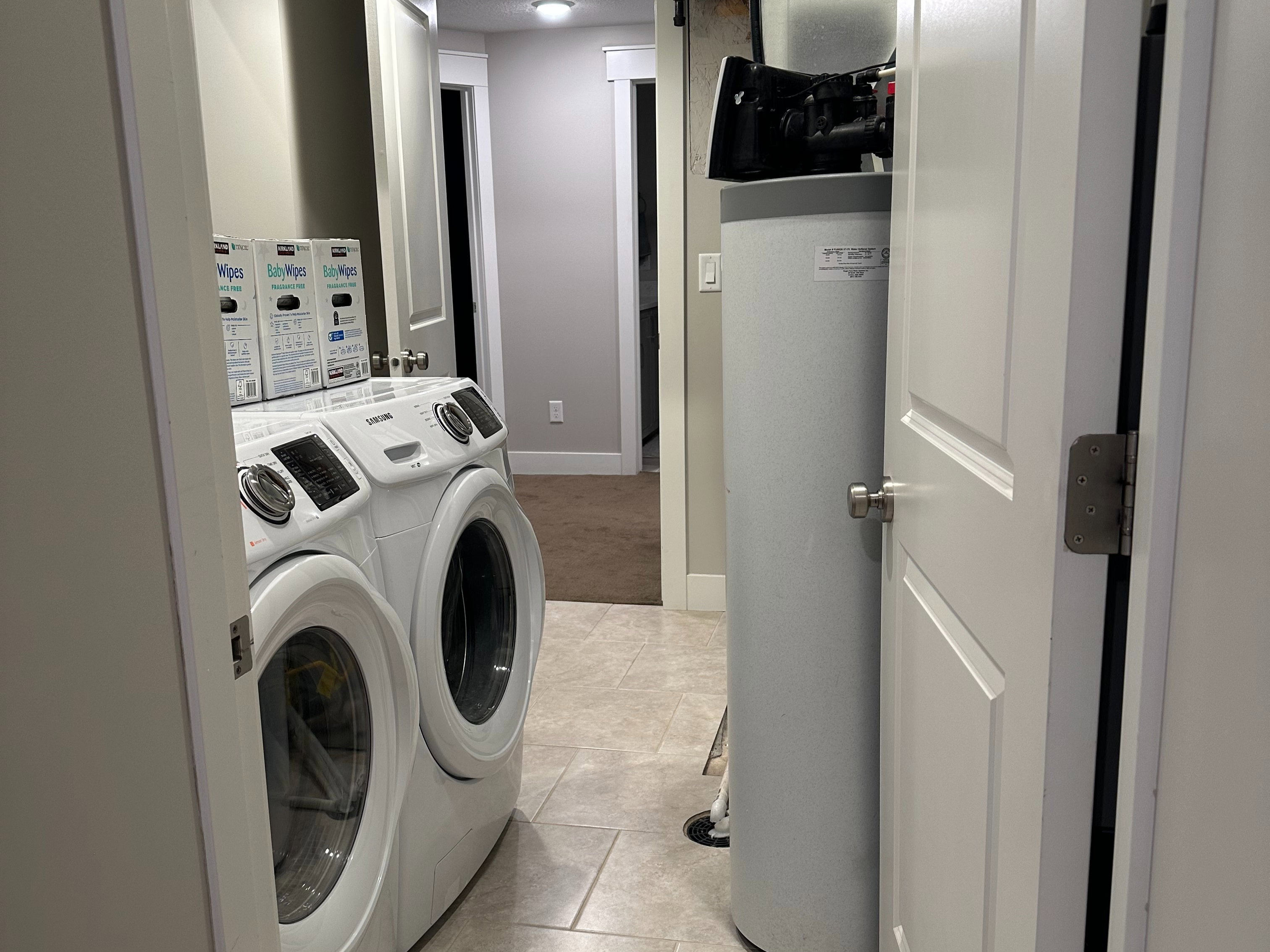 Laundry area featuring tile flooring, recessed lighting, and a water softener