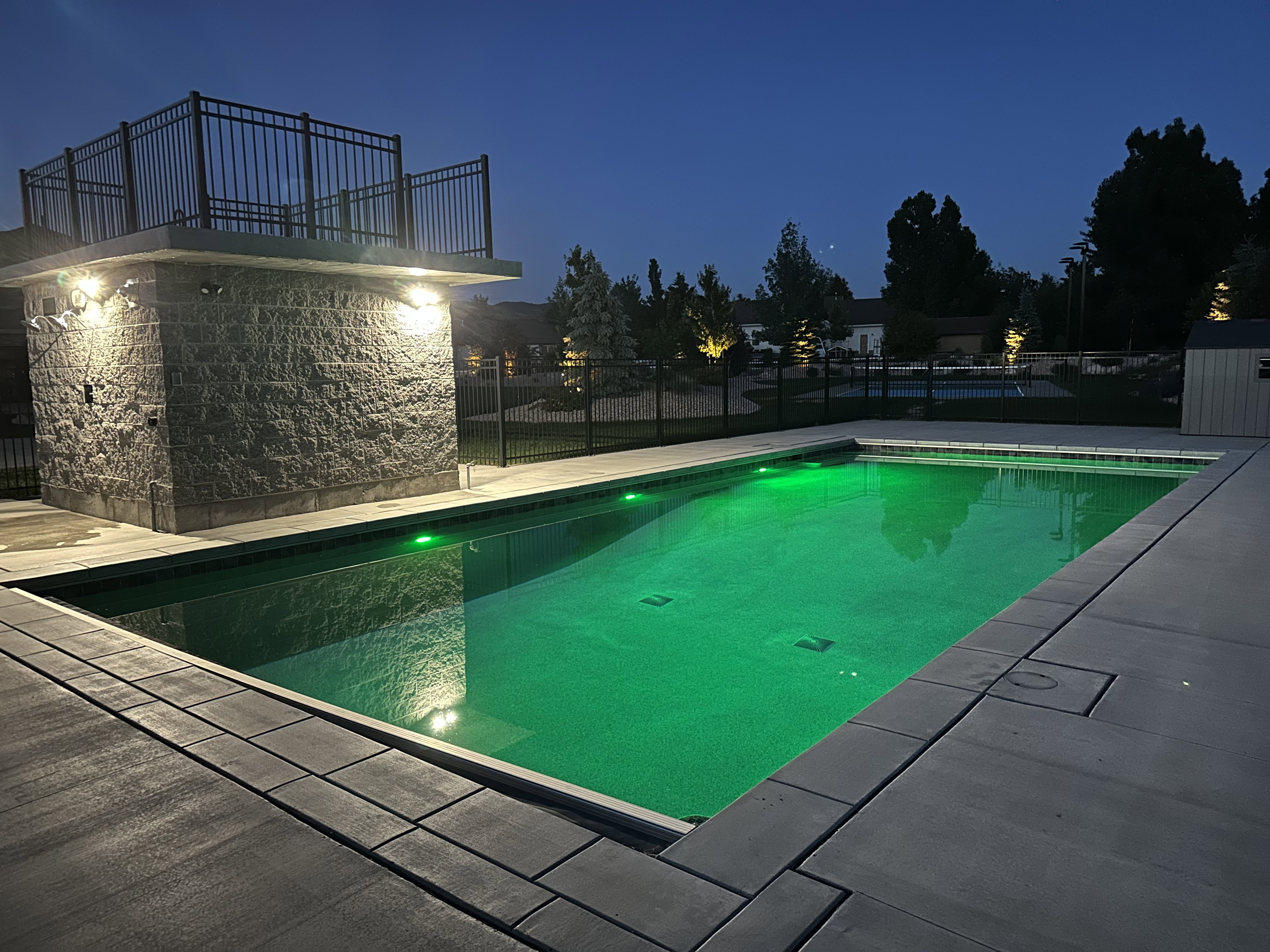 Rectangular inground pool with green accent lighting