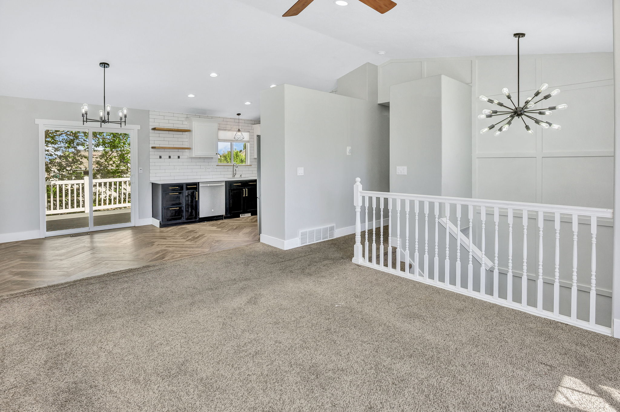 Open-concept living area with vaulted ceilings and a modern Sputnik chandelier