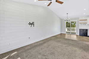 Vaulted ceiling with wood-finish ceiling fan and recessed lighting