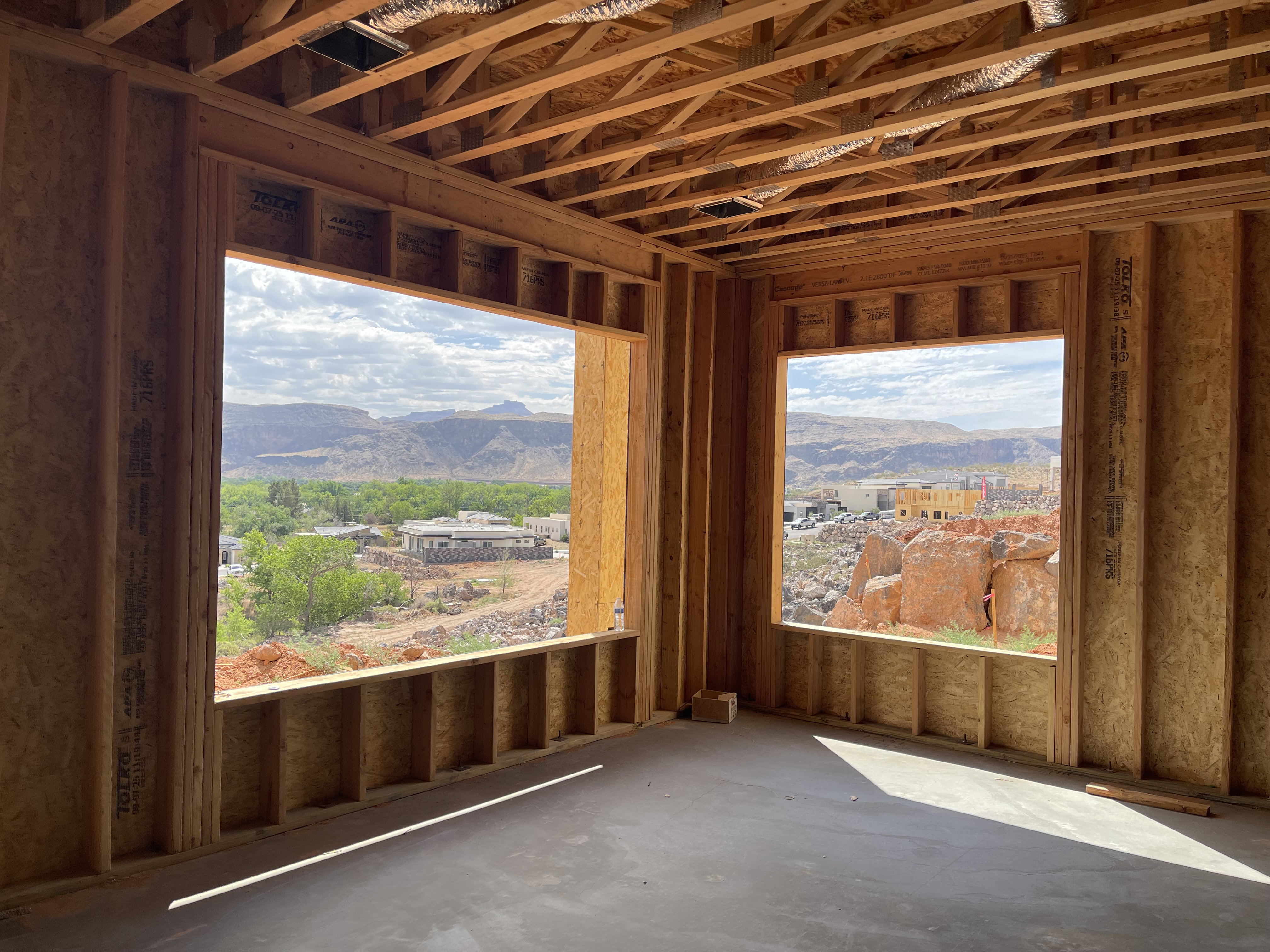 Open framing featuring two large window openings showcasing distant mountains and verdant trees