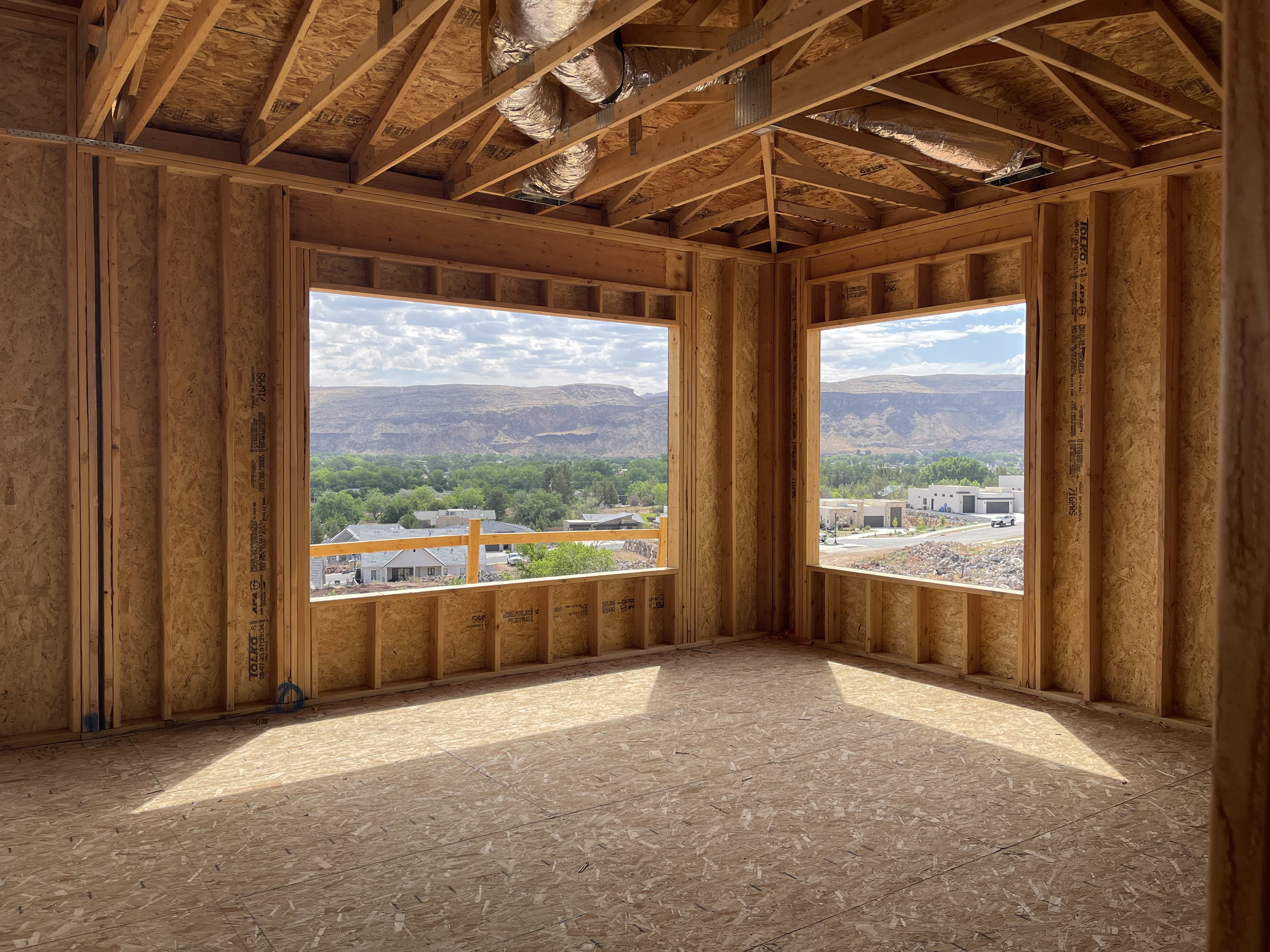 Unfinished interior framing with exposed ceiling joists and subflooring