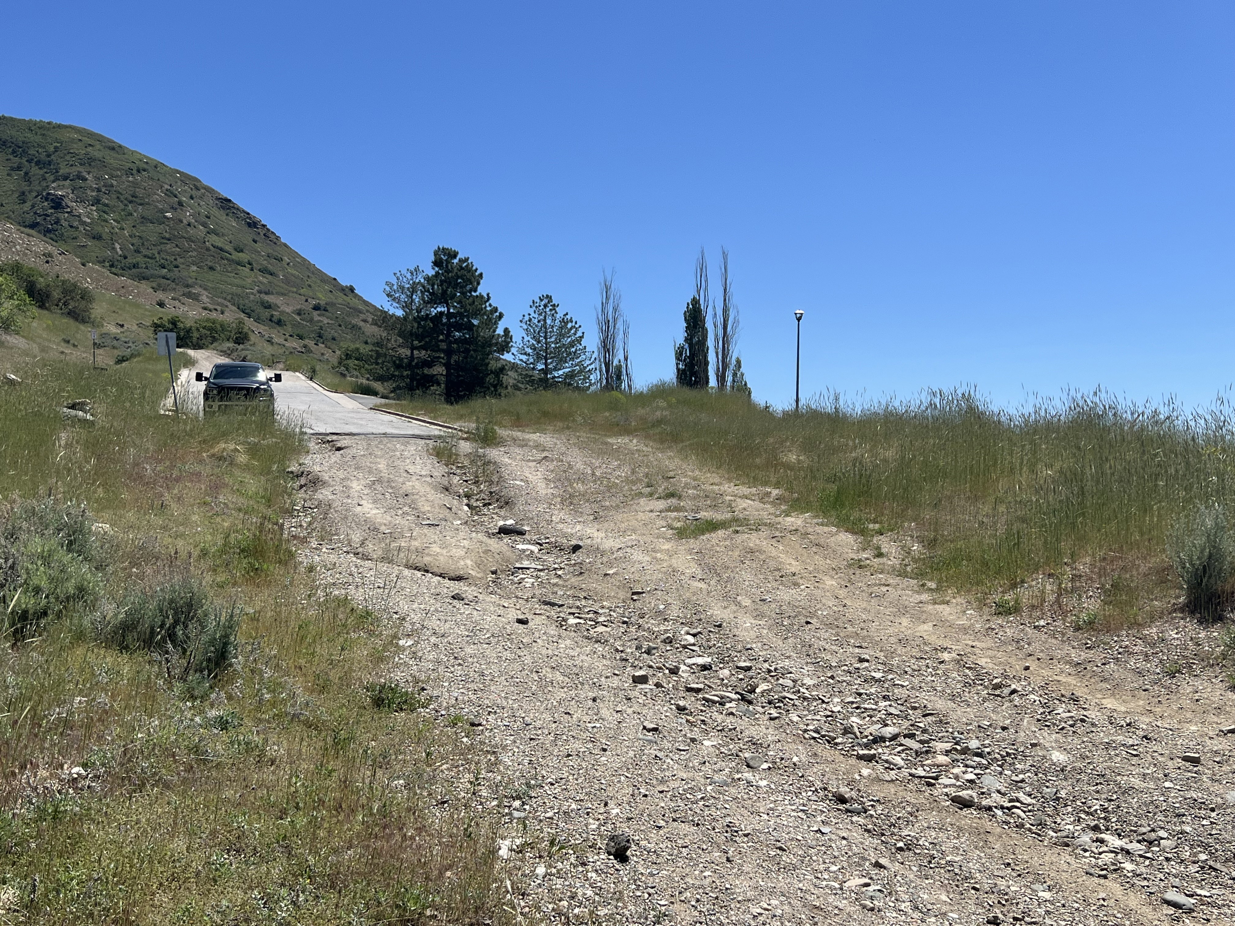Expansive undeveloped lot featuring a gradual incline, natural terrain, and distant mountainous backdrop