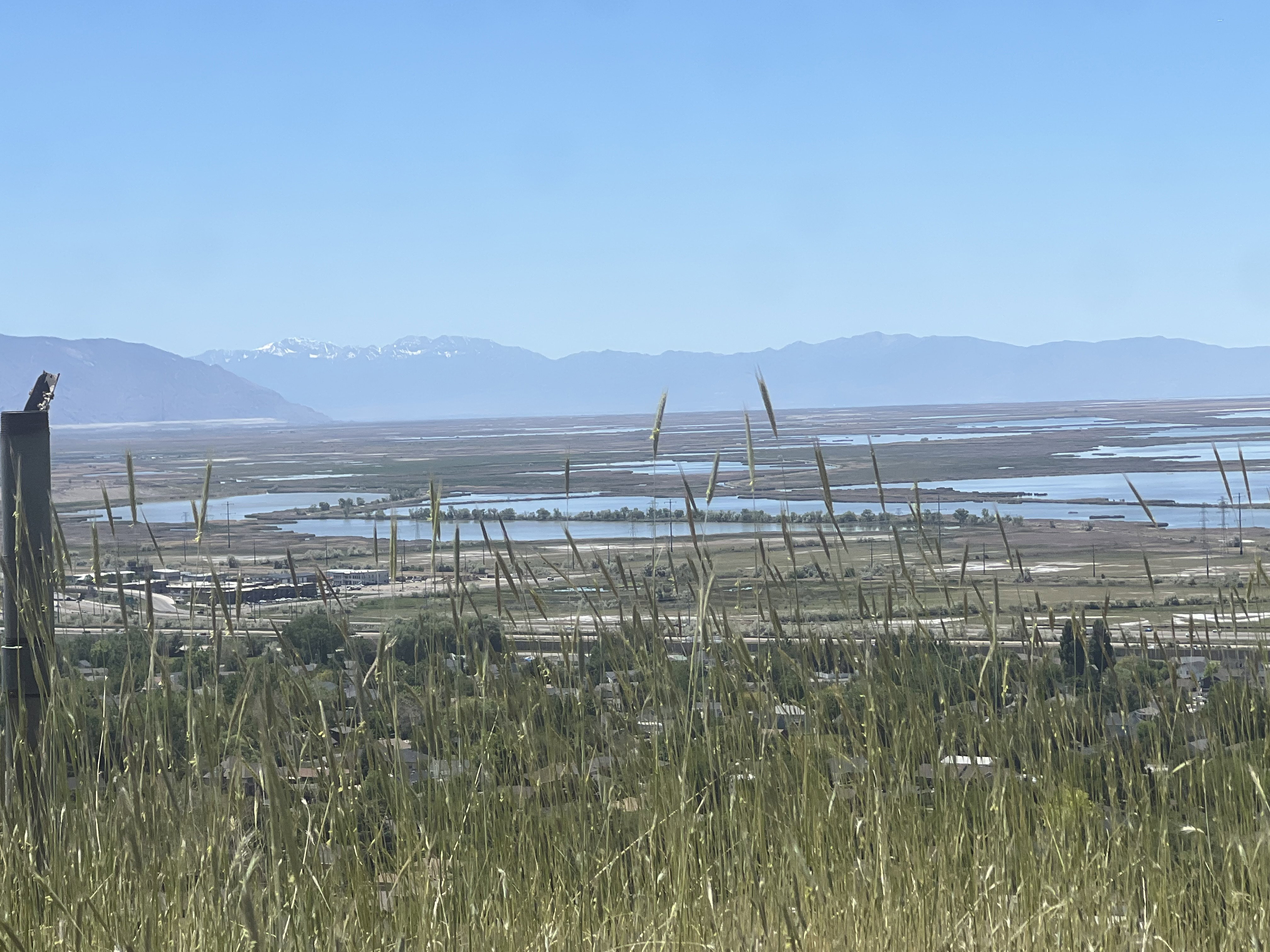 Expansive mountain and lake scenery with distant water bodies and a clear horizon