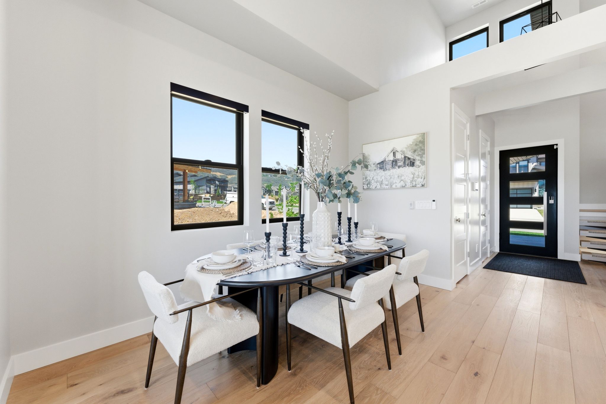 Light wood-finish flooring complements the white walls and high ceilings