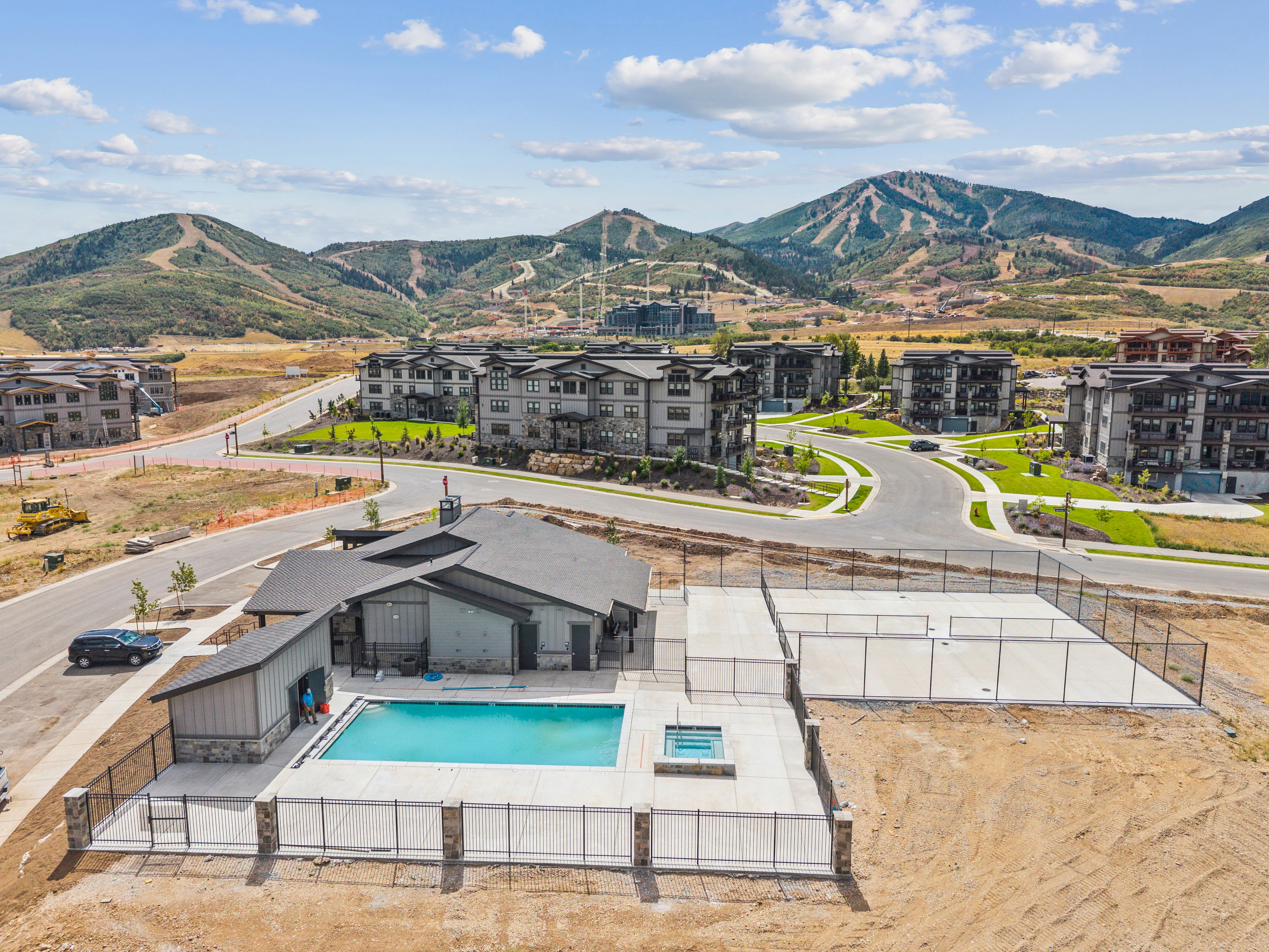 Community amenities featuring a swimming pool, integrated spa, and two enclosed courts