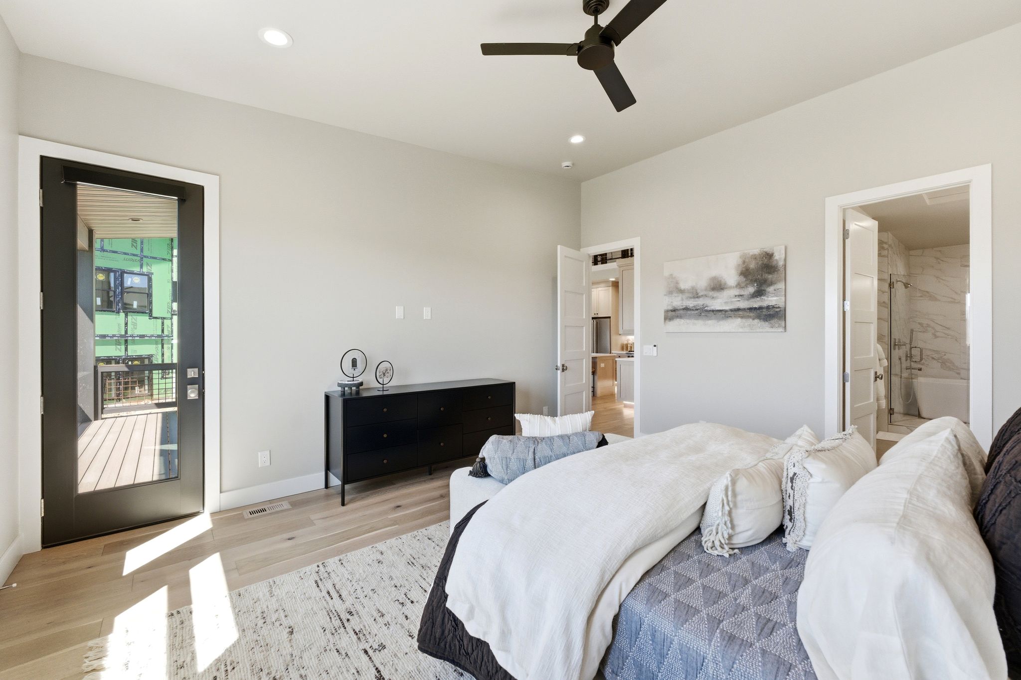 Spacious room featuring light wood-finish flooring, recessed lighting, and a contemporary ceiling fan