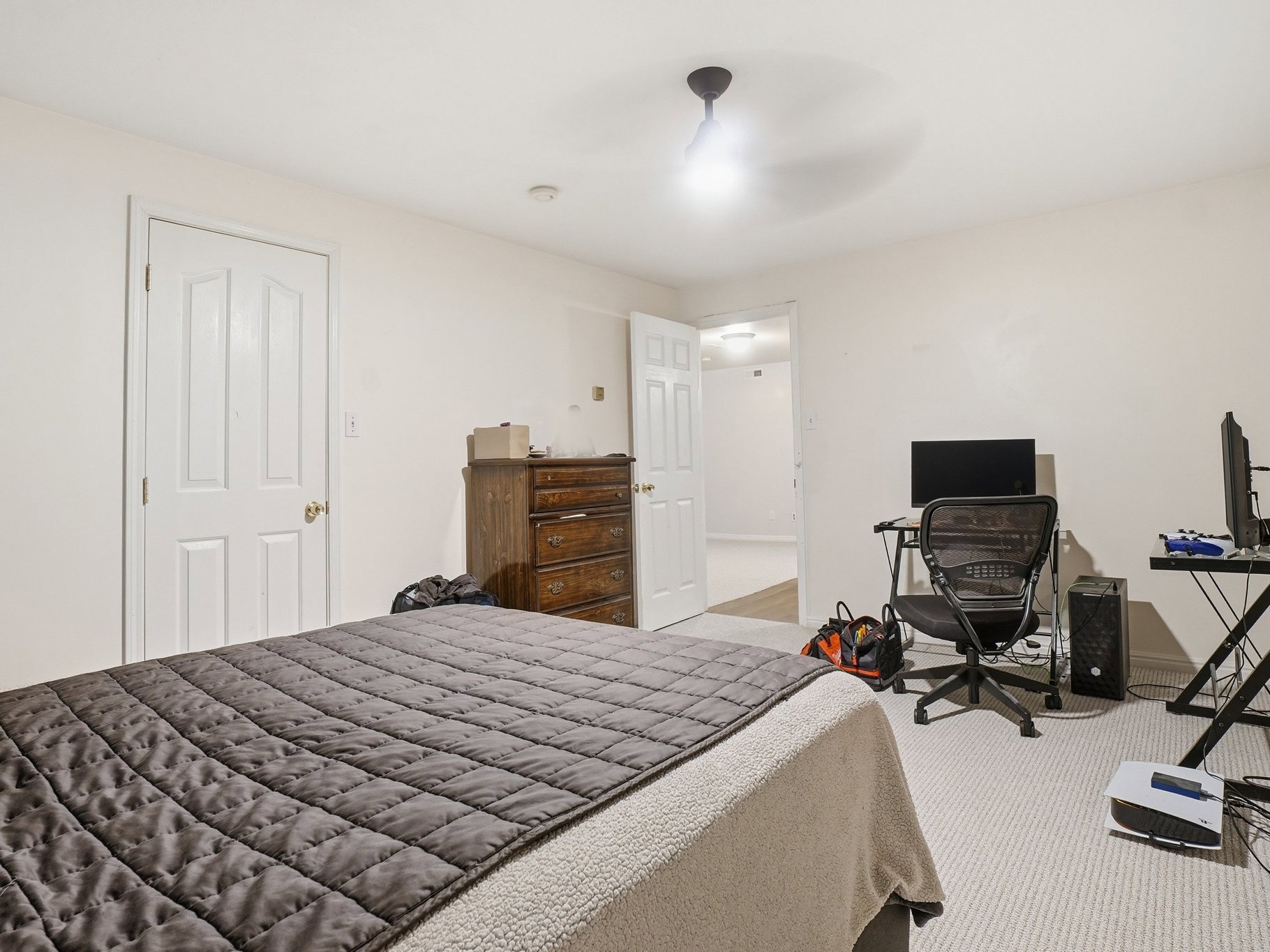 Carpeted room featuring white walls and white paneled doors