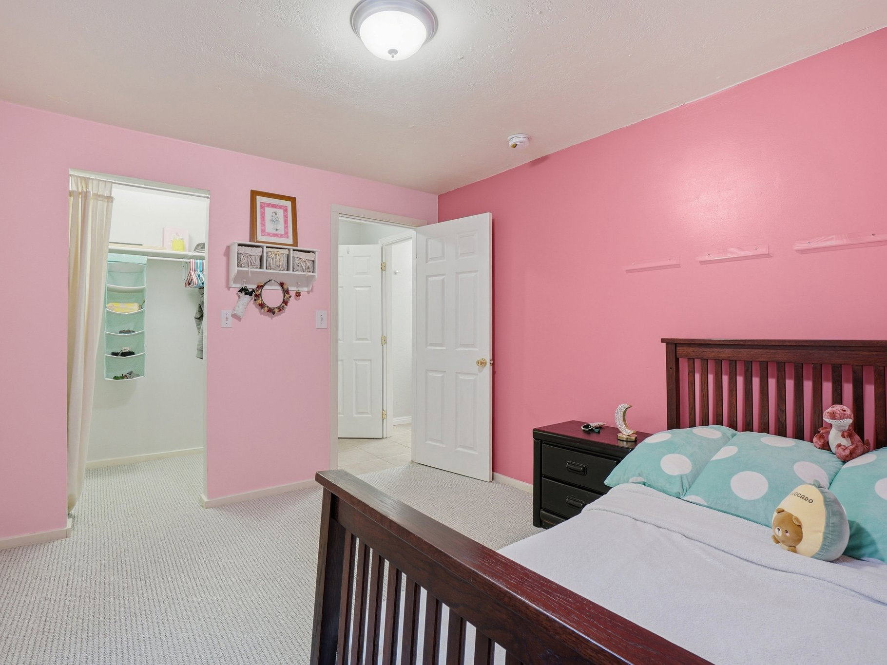 Bedroom featuring textured carpet flooring and a ceiling-mounted light fixture
